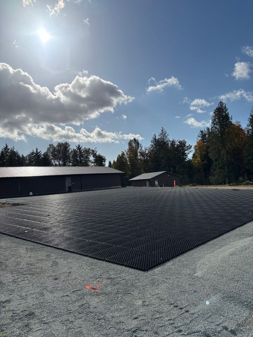Newly installed porous pavement at a construction site under a sunny sky.